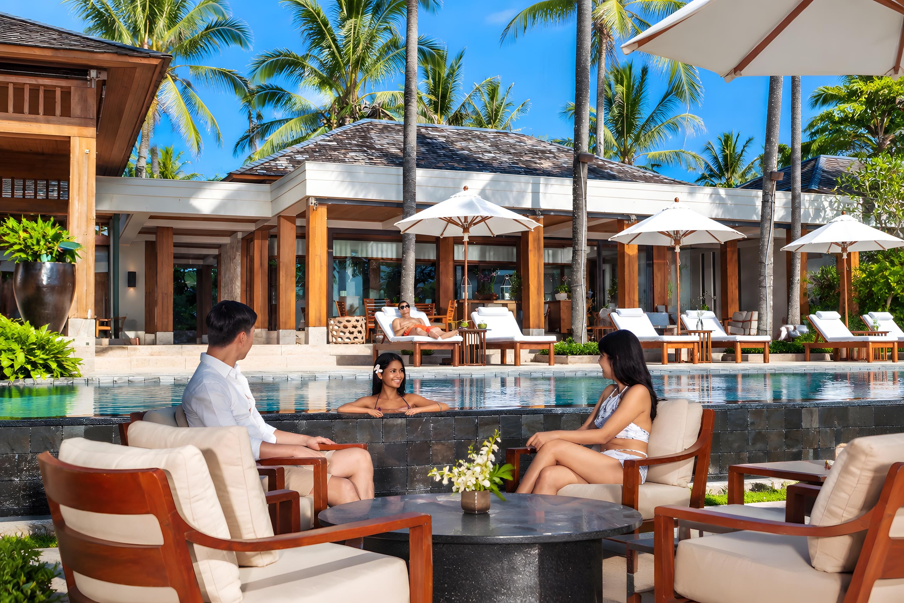 A poolside area with lounge chairs, umbrellas, and a clear view of the pool.