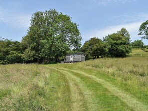 A rural setting with a small wooden structure, possibly a cabin, surrounded by trees and grassy fields. - 0 bedroom accommodation in West Bagborough, near Taunton (West Bagborough, near Taunton)