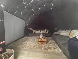 A cozy living room with a couch, a coffee table, and a unique ceiling design. - Weets Hill Dome - UKC9598 (Earby)