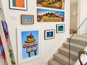A wall with various framed pictures, including a Lorraine Motel sign. - Balcony 1-Bed Apartment Near Sydney Road (Brunswick)