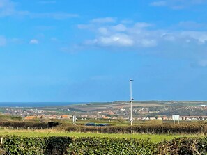 A rural landscape with a clear sky, a street lamp, and a distant town. - 1 bedroom accommodation in Whitby (Whitby)