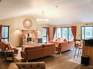 A spacious living room with a fireplace, sofas, and a dining area. - The Farmhouse - UKC9936 (Gateshead)