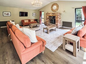 A living room with a fireplace, sofas, and a television. - The Farmhouse - UKC9936 (Gateshead)