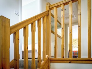 A wooden staircase with a handrail, carpeted steps, and a white wall. - The Gardener's Cottage - UKC6966 (Carnoustie)