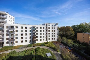 A multi-story residential building with balconies, a landscaped courtyard, and a clear sky. - Warsaw | Zwycięzców 40 | Comfortable Apartment | Remote Work (Warszawa)