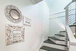 A staircase with white walls and a white railing, leading to an upper floor. - Furnished, Dog-Friendly Old Village Retreat w/ Fabulous Patio!  Extended-Stay, 30+ Day Leases Only (Mount Pleasant)
