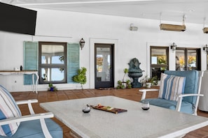 A spacious patio with a white table, blue chairs, and a variety of plants. - Pool + Hot Tub | Fire Pit + Hammock | Hilltop Valley Views | Vino Vista Villa (Paso Robles)