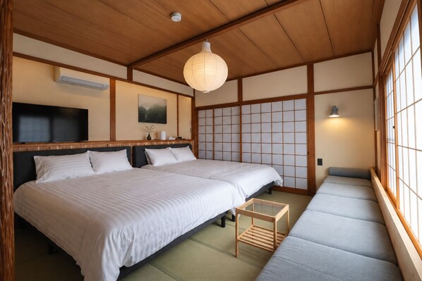 A traditional Japanese-style room with tatami flooring, a low wooden ceiling, and sliding shoji doors. - KihadaNikko (Nikko)