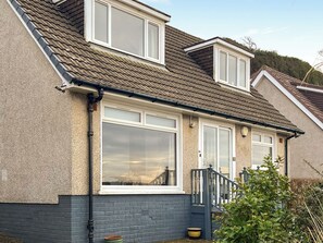 A residential building with a sloped roof, large windows, and a visible staircase leading to the entrance. - 3 bedroom accommodation in Wemyss Bay (Wemyss Bay)