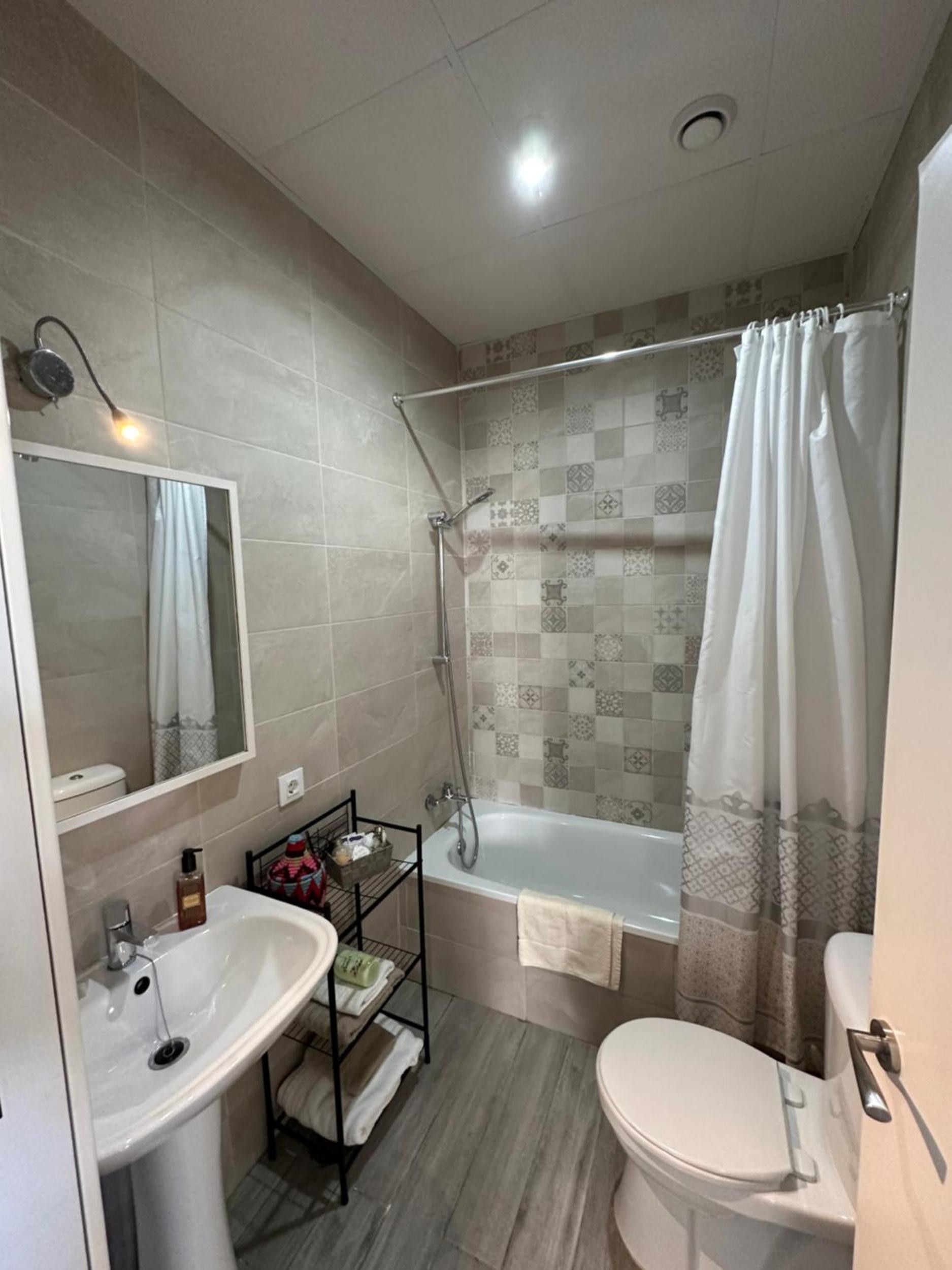 A bathroom with a sink, toilet, bathtub, and shower.