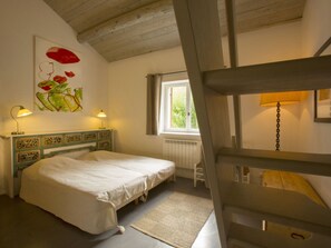 A bedroom with a bed, a window, a painting, and a lamp. - Charming Holiday Home With Pool - 904 ANS (Ansouis)