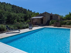 A swimming pool with lounge chairs and a stone building in the background. - Charming Holiday Home With Pool - 904 ANS (Ansouis)