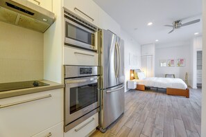 A modern kitchen with stainless steel appliances, a built-in oven, and a microwave. - Steps to Santa Monica Beach & Pier! Monthly Studio (Santa Monica)