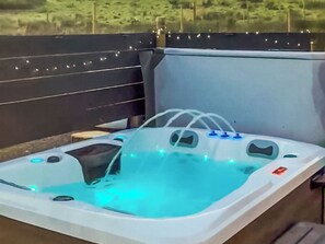 A hot tub with a transparent cover, a control panel, and a view of the surrounding area. - 1 bedroom accommodation in Lerags (Lerags)