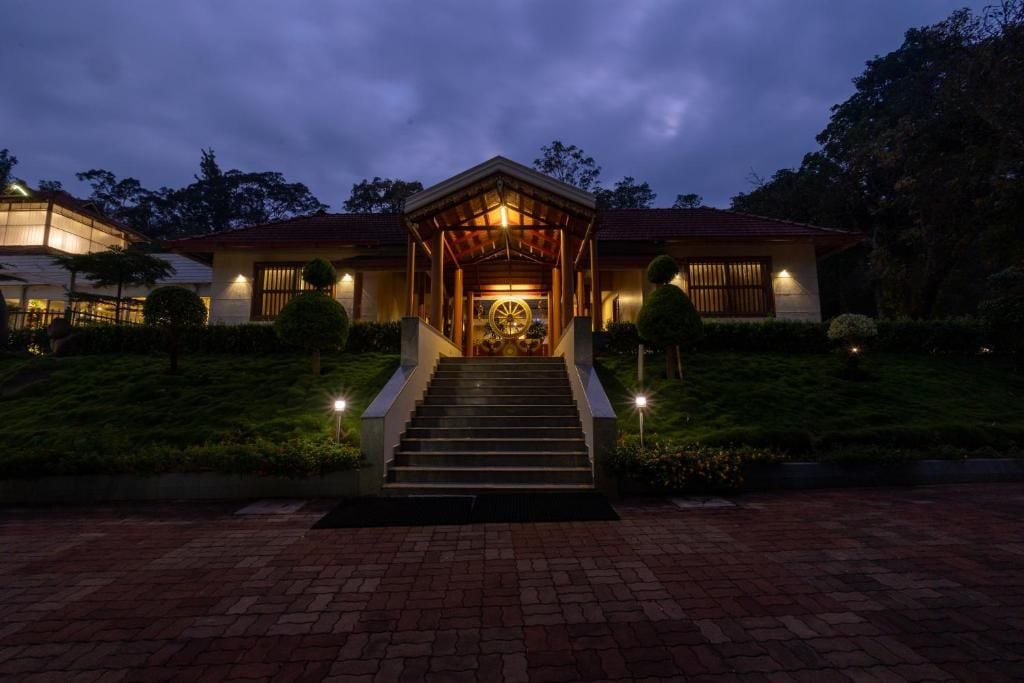 Un edificio con un ingresso centrale, una scalinata che vi conduce e un percorso ben illuminato.