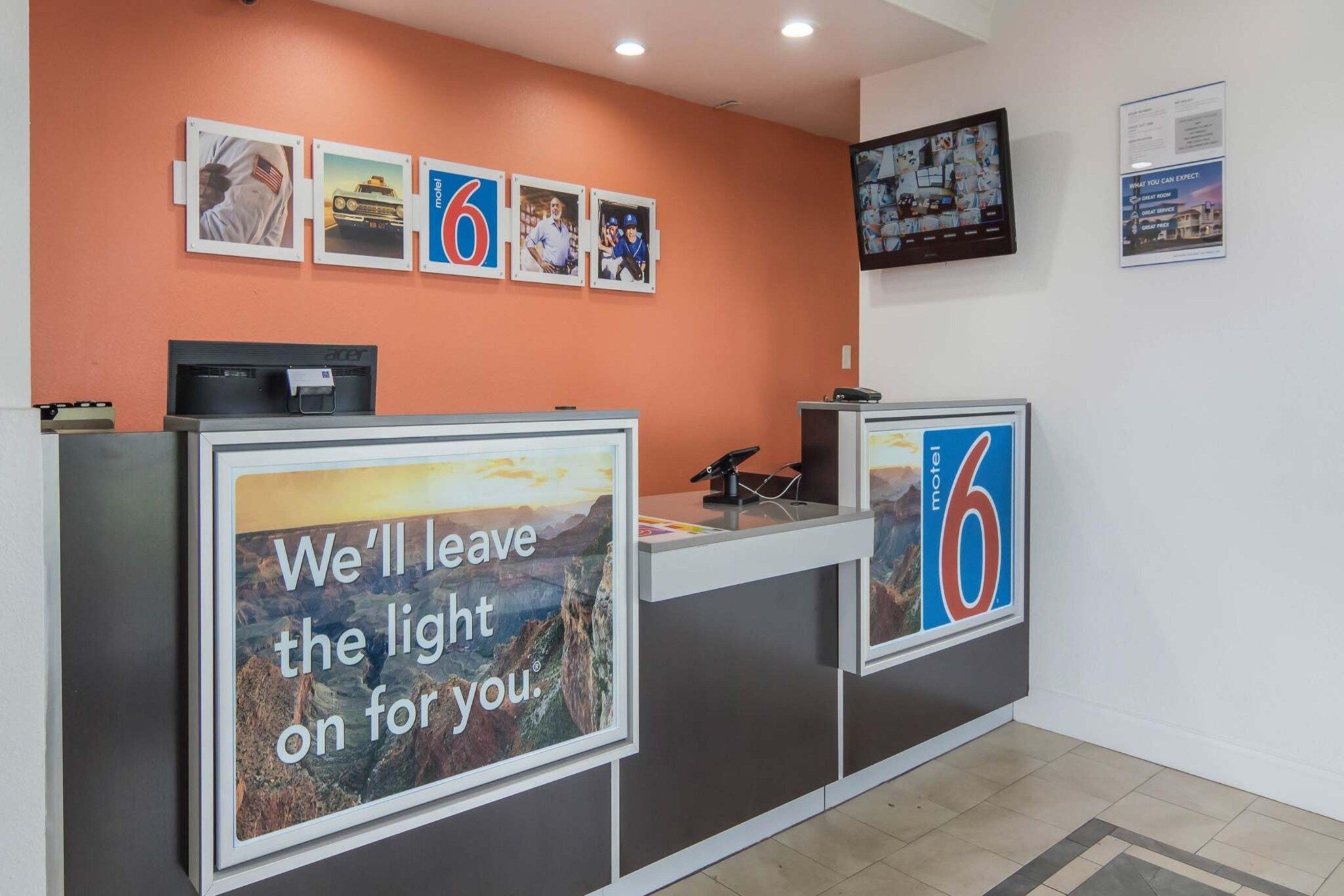 A reception desk with a large sign stating 'We'll leave the light on for you.'