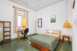 A bedroom with a bed, a desk, a chair, a ladder, a hanging lamp, and a wall-mounted picture. - Laoxao Memories (Đà Nẵng)