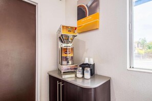 A coffee machine on a counter with two milk dispensers and a coffee cup holder. - 2 Full Beds | Non-Smoking (Bakersfield)