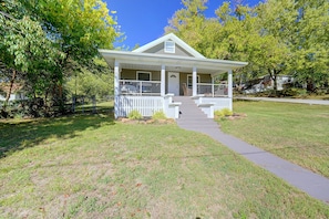 A single-story house with a front porch, a visible door, and a small front yard.