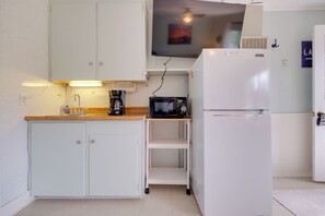 A compact kitchen with white cabinets, a coffee maker, a microwave, and a refrigerator. - Walk to Beach! Cabin Suite on Lake Huron (Greenbush)