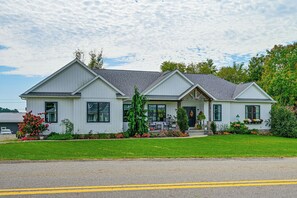 A two-story house with a front porch, a garage, and a well-maintained lawn. - Walk to Apple Valley Lake: Patio, Fire Pit (Howard)