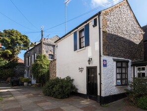 A traditional building with a stone facade, a black door, and a sign indicating it is a pub. - Barnaby's Lodge - UK51951 (Broadstairs)