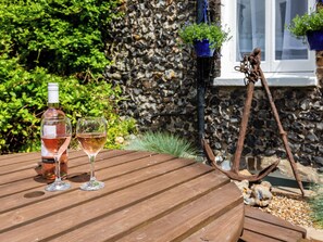 A wooden table with a bottle and two glasses of wine. - Smuggler's Cottage - UK51952 (Broadstairs)