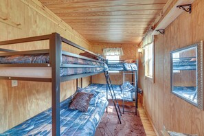A bunk bed room with wooden walls and a window. - Streamside Tallmansville Retreat: Fish & Unwind (Tallmansville)