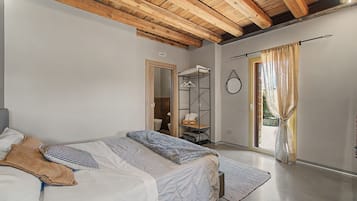 Une chambre avec un lit superposé, une armoire, une salle de bain et une vue par la fenêtre.