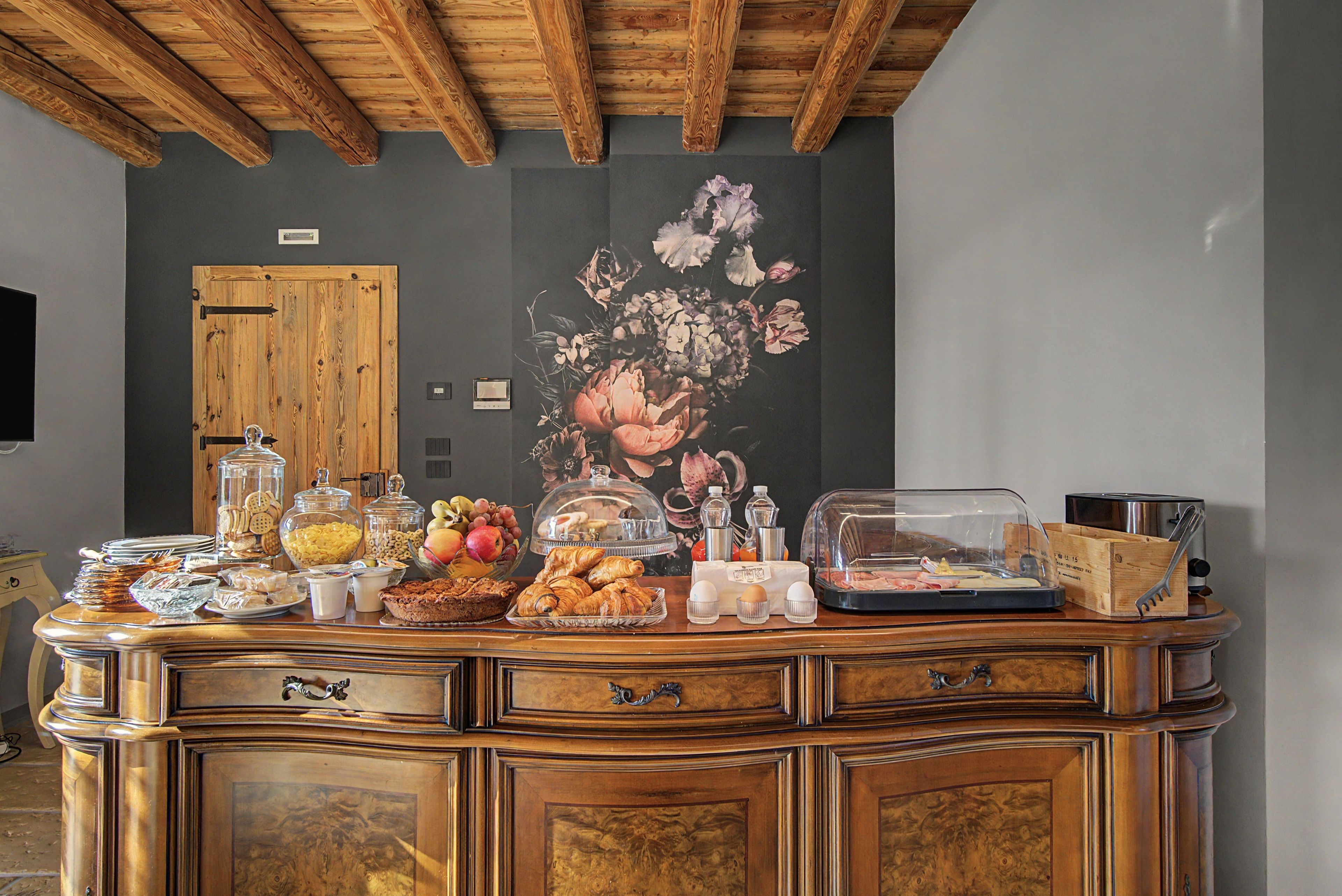 Un buffet proposant une variété de plats, agrémenté d’une fresque florale sur le mur.