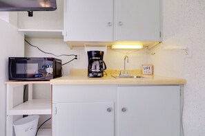 A compact kitchenette with a microwave, coffee maker, and a small sink. - Lake Huron Cabin Suite w/ Beach Access (Greenbush)