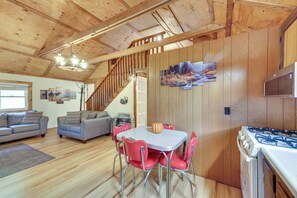 A wooden interior with a dining area, kitchen, and living space. - Fish the Right Fork River: Tallmansville Home (Tallmansville)