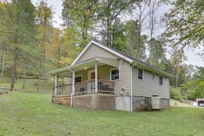 A single-story house with a front porch and a small attached garage. - Fish the Right Fork River: Tallmansville Home (Tallmansville)