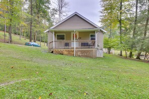 A single-story house with a front porch, a garage, and a small deck. - Fish the Right Fork River: Tallmansville Home (Tallmansville)