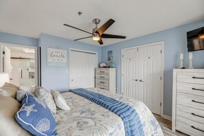 A bedroom with a bed, dresser, and ceiling fan. - Walk to Beach & Northside Park! Monthly Stay Condo (Ocean City)