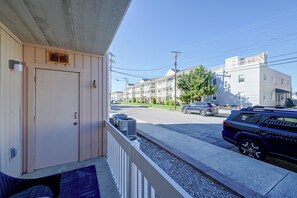A residential area with a house, parked cars, and a clear sky. - Walk to Beach! Updated Brigantine Retreat (Brigantine)