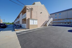 A multi-story building with balconies, a parking area, and a clear sky. - Walk to Beach! Updated Brigantine Retreat (Brigantine)