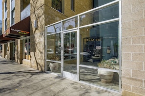 A storefront with large glass windows and a sign for 'Bella Via.' - Viva La Dolce Vita in the Heart of Little Italy! (San Diego)