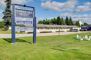A sign for Sunrise Side Resort with Lake Huron and Suites Cabins. - Lakefront Escape at Sunrise Side Resort (Greenbush)