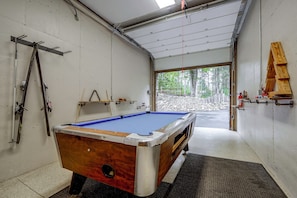 A pool table in a room with a garage door leading to a forested area. - Game Room, Hot Tub! Retreat 3 Mi to Holiday Valley (Ellicottville)