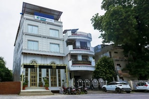 A multi-story building with a sign for 'Freebo' on the top. - Treebo Premium Vedic Stays (Prayagraj)
