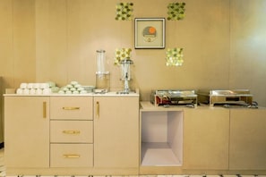 A kitchenette with a countertop, a sink, and a cabinet with drawers. - Treebo Premium Vedic Stays (Prayagraj)