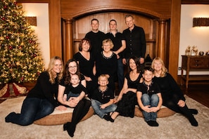 A family group photo with a Christmas tree in the background. - Balvonie House, Grand Scottish Mansion, Hot Tub with Island Views. 12 Bedrooms (Skelmorlie)