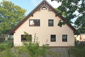 A two-story house with a gabled roof, multiple windows, and a fenced yard. - 1 in the Lili Marleen House (Ostseebad Prerow)