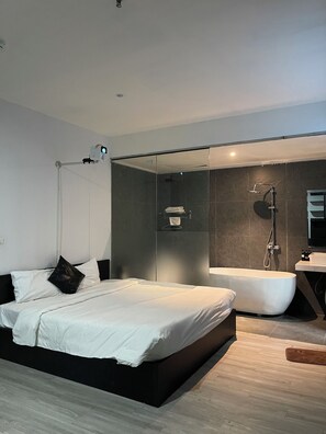 A modern bedroom with a large bed, a walk-in shower, and a separate bathroom. - Atlantis Tran Duy Hung Apartment (Yen Hoa)