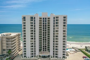 A high-rise hotel with multiple balconies, a pool area, and a view of the beach. - #1404 Seychelles Oceanfront Traffic Free Beach (Daytona Beach Shores)