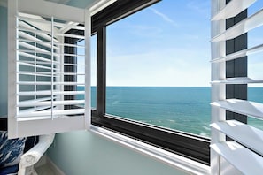 A room with a view of the ocean through a window with white blinds. - #1404 Seychelles Oceanfront Traffic Free Beach (Daytona Beach Shores)