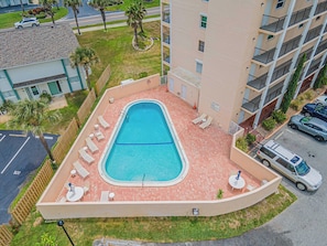 A residential building with a swimming pool, outdoor seating, and a parking area. - 201 Tidewater in Ponce Inlet, FL (Ponce Inlet)