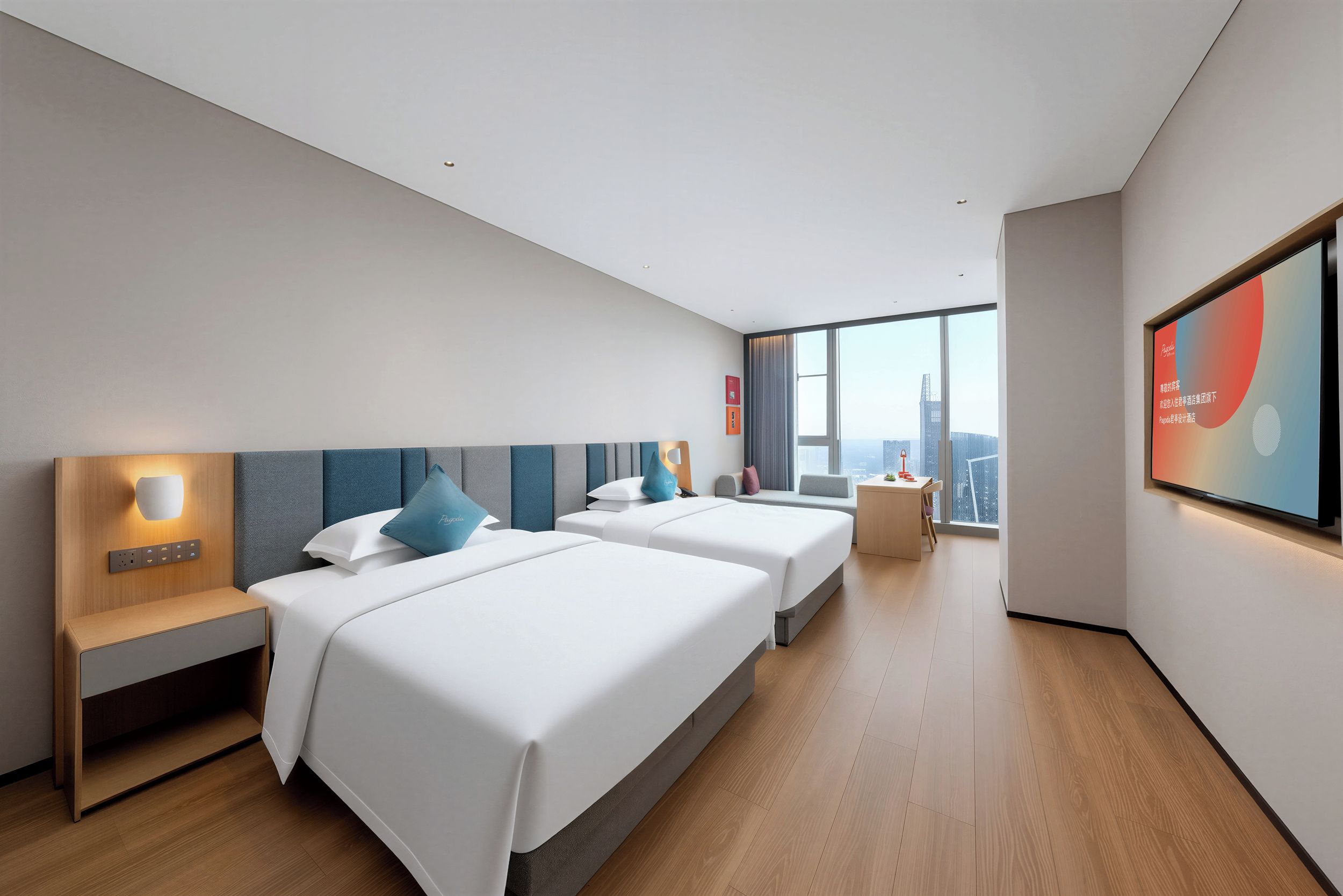 A hotel room with two beds, a desk, a chair, a large window with a city view, and a flat-screen TV mounted on the wall.
