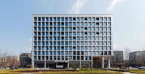 A modern multi-story building with a grid of windows and a flat roof. - Base-CAOHEJING Hotel Residence (Shanghai)